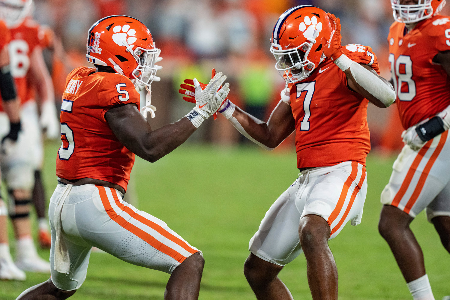 Clemson defensive end K.J. Henry (5) and defensive end Justin Mascoll (7) celebrate after a stop against Louisiana Tech on fourth down Saturday in Clemson, S.C.
