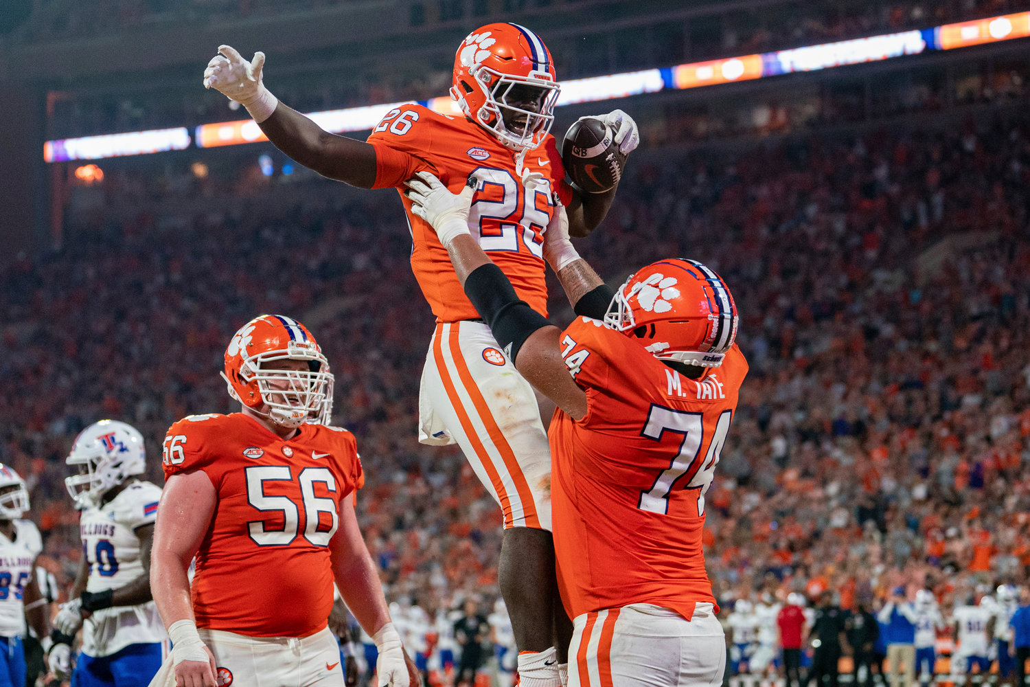 Clemson running back Phil Mafah (26) celebrates his touchdown against Louisiana Tech with offensive lineman Marcus Tate (74) during the second half of an NCAA college football game Saturday, Sept. 17, 2022, in Clemson, S.C. (AP Photo/Jacob Kupferman)