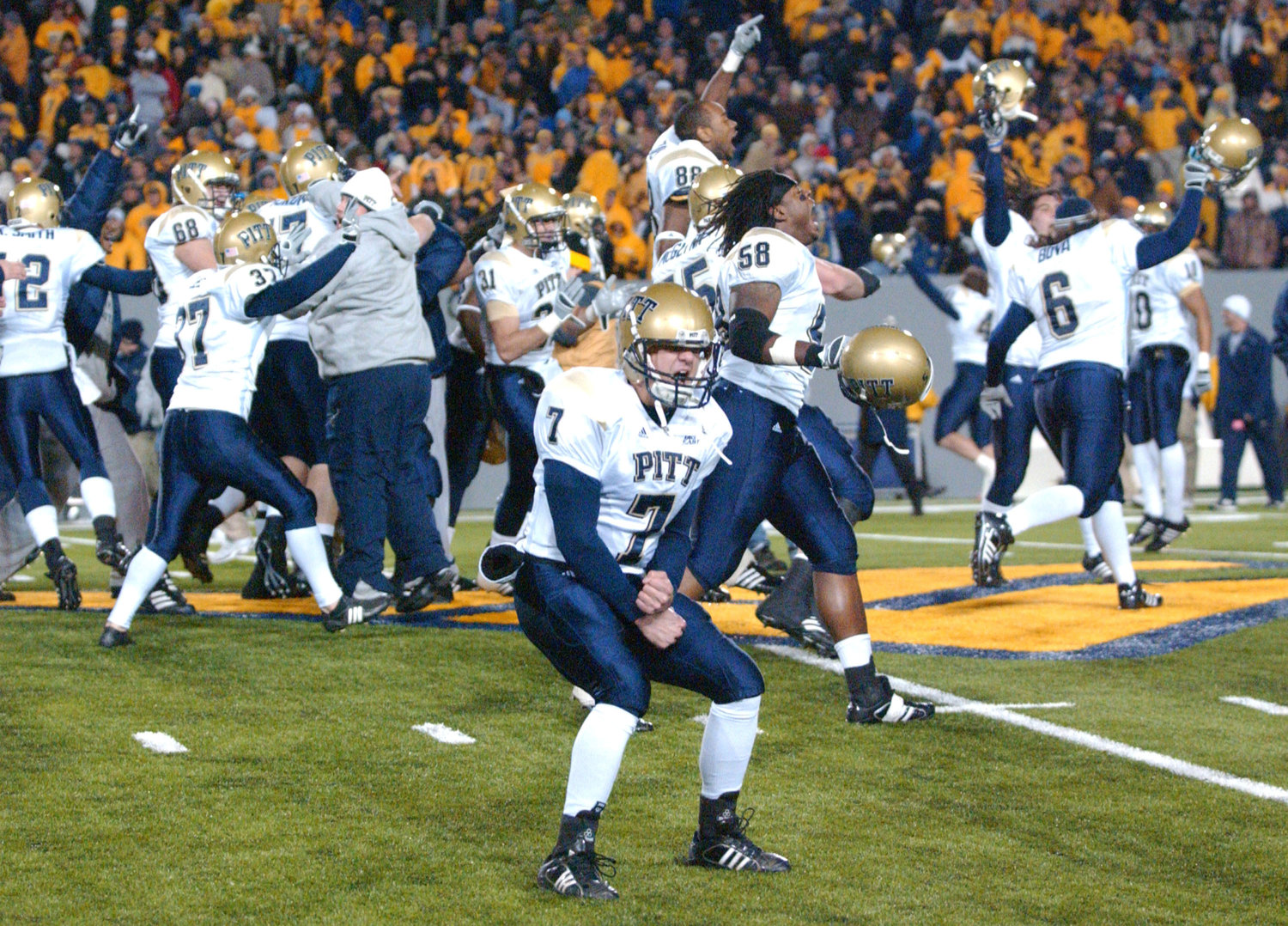 FILE - Pittsburgh's Steve Malinchak (7) and teammates celebrate their 13-9 upset win over No. 2 West Virginia in an NCAA college football game Dec. 1, 2007, in Morgantown, W.Va. The rivalry between the longtime rivals will be renewed following an 11-year hiatus on Thursday, Sept. 1, 2022, when the 17th-ranked Panthers host the Mountaineers. (AP Photo/Jeff Gentner, File)
