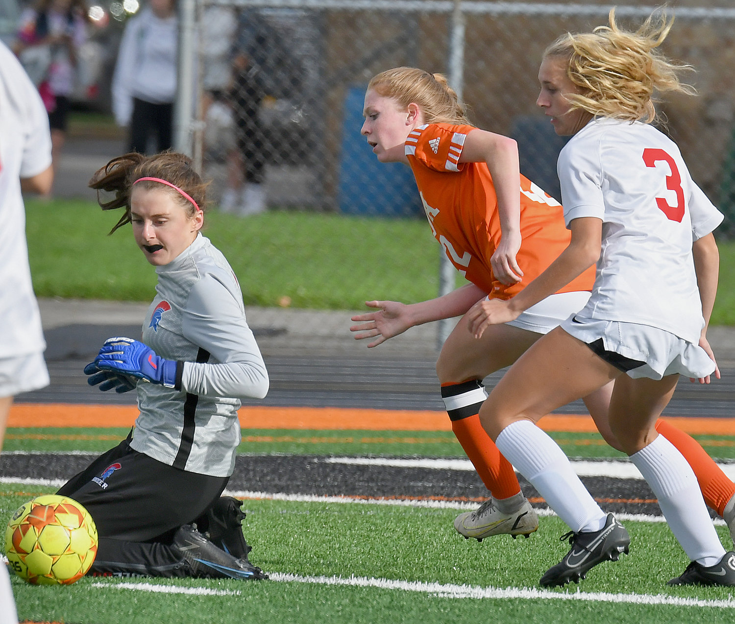 New Hartford goalie Savannah Cole slides to make a save in front of New Hartford teammate Grace Serafin and Rome Free Academy's Brynn Furbeck on Thursday at RFA Stadium. New Hartford won 8-1 to continue a unbeaten streak that is at 46 games.