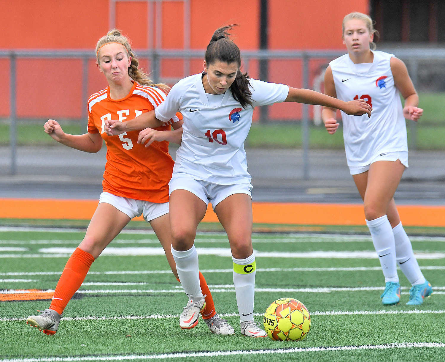 New Hartford's Talia Vitullo boxes out RFA's Brooke Egresits from the ball in the first half Thursday at RFA Stadium in Rome. Willa Pratt, who had two goals and two assists in the game, looks on.