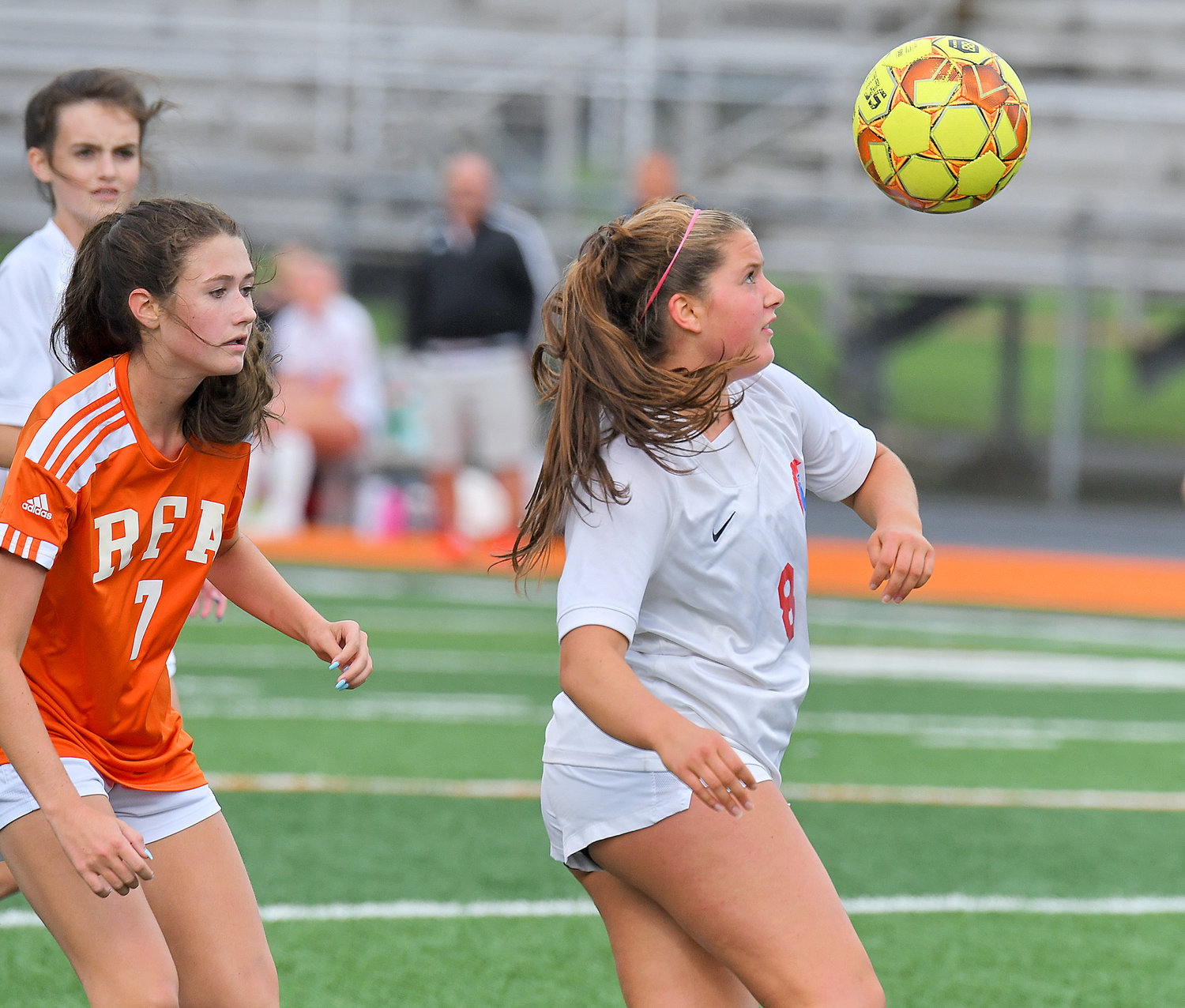 New Hartford's Mia Roberts looks to make a play as RFA's Hannah Gann challenges behind her Thursday at RFA Stadium.