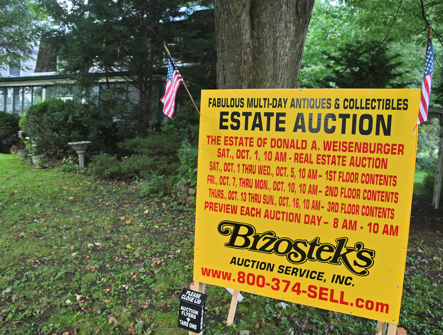 A sign in front of 907 N. George St. announces the auction dates and times for the house and all the contents inside, which belong to the estate of Donald A. Weisenburger.