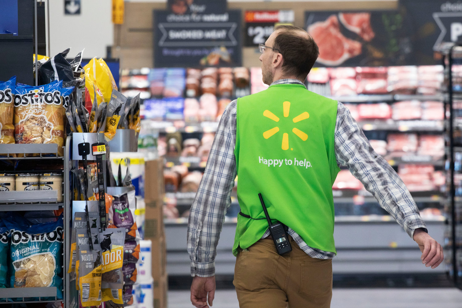A Walmart associate works at a Walmart Neighborhood Market, Wednesday, April 24, 2019, in Levittown, N.Y.  The nation‚Äôs two major retailers _ Walmart and Target_ plan to push deals and other marketing gimmicks for the holiday shopping season earlier than last year as soaring inflation spurs customers to get a jump start on gift giving.   (AP Photo/Mark Lennihan, File)