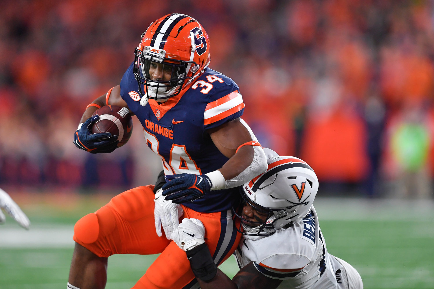 Syracuse running back Sean Tucker (34) is tackled by Virginia linebacker Chico Bennett Jr. (15) during the first half on Friday night in Syracuse.
