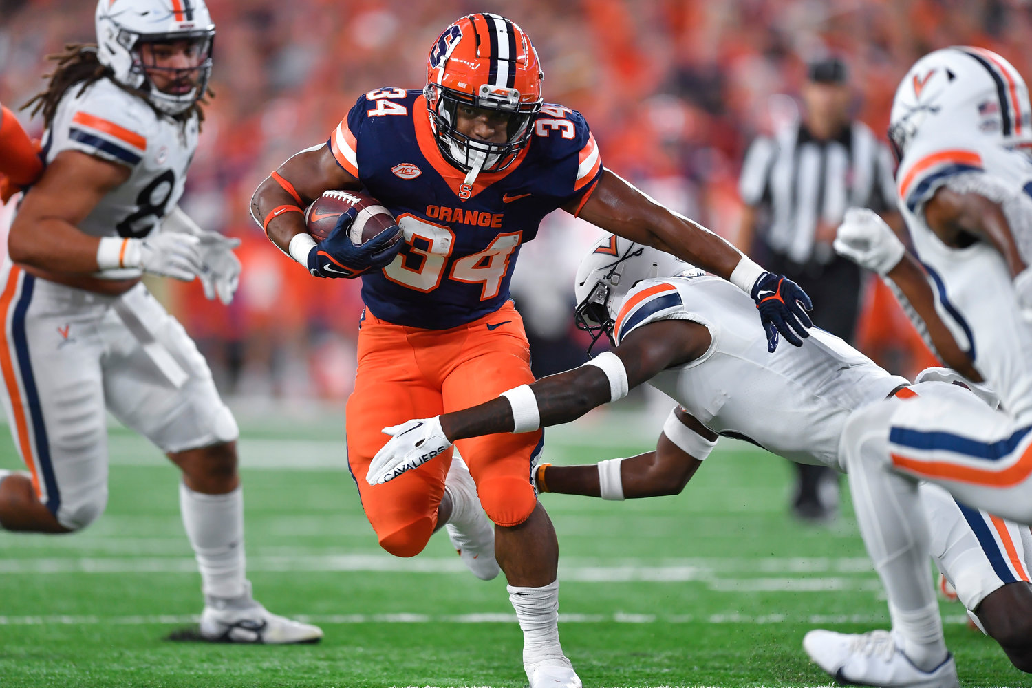 Syracuse running back Sean Tucker (34) tries to break a tackle by Virginia cornerback Anthony Johnson during the first half on Friday night in Syracuse.