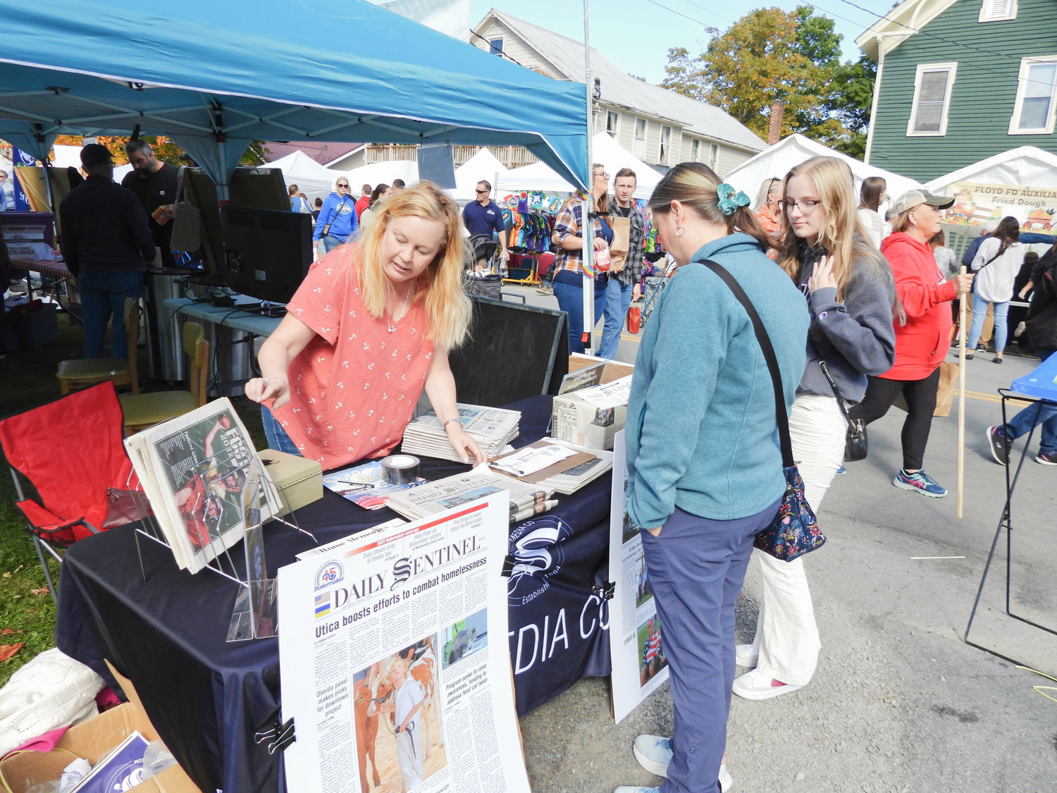 The Remsen Barn Festival of the Arts saw Main Street packed with people looking to sample good foods and take home unique arts and crafts on Saturday, Sept. 24 in the town of Remsen. The Festival made a return after a leave of absence due to COVID-19. Pictured is the Daily Sentinel's Business Manager Eileen Pierson, speaking with Festival attendees about the Sentinel Media Company's publications and what it has to offer.