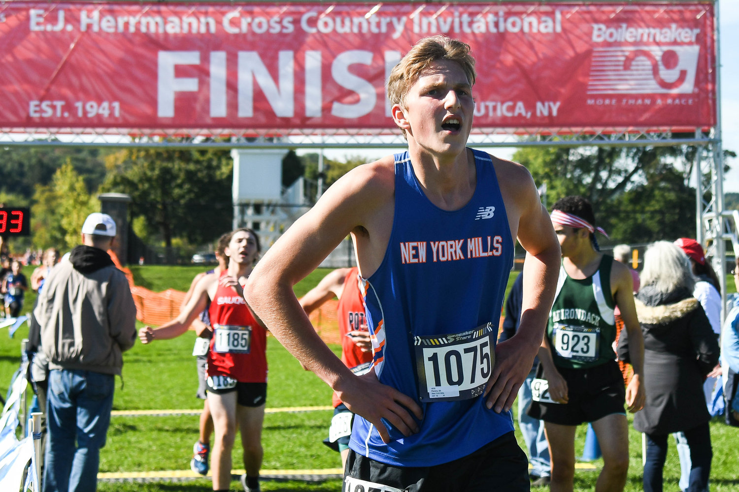 New York Mills runner Eli Pereira catches his breath after crossing the finish line during the 79th E.J. Herrmann Invitational on Saturday at Proctor Park in Utica. He finished 96th out of 171 runners in the boys varsity race.