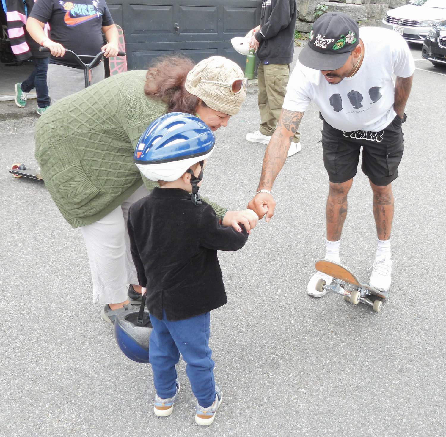 Emanuel “Manny” Santiago bumps fist with a young skater at Lenox Skate Park on Saturday, Sept. 24. Santiago was in town as part of his efforts to help youngsters develop life building skills as well as social and emotional learning opportunities through skateboarding.