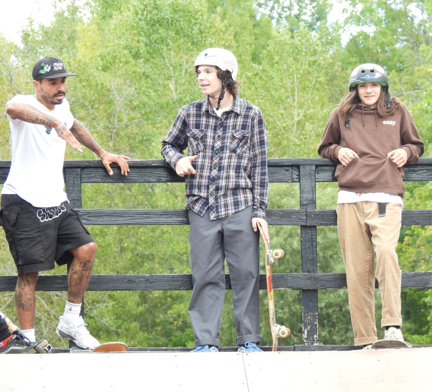 Emanuel “Manny” Santiago shares some skateboarding tips with some fellow enthusiasts of the sport at the Lenox Skate Park on Saturday, Sept. 24. Santiago, an Olympian and professional skateboarder, was in Canastota as part of his efforts to support youth development.