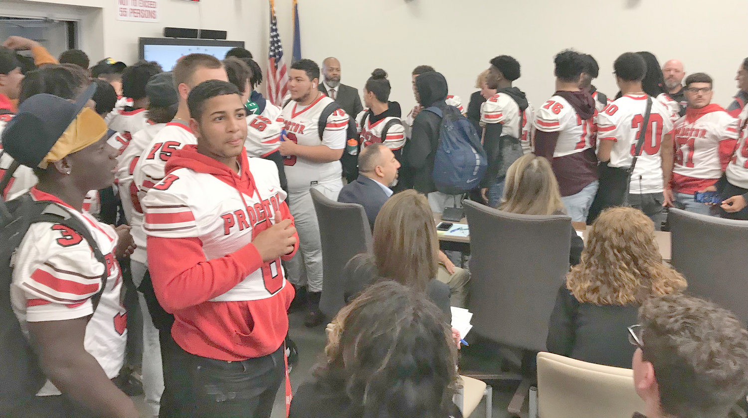 Members of the Thomas R. Proctor football team, along with fellow students from the girls varsity tennis team and the cheerleading squad, visited the Utica City School District Board of Education and their audience Tuesday night at their monthly meeting.