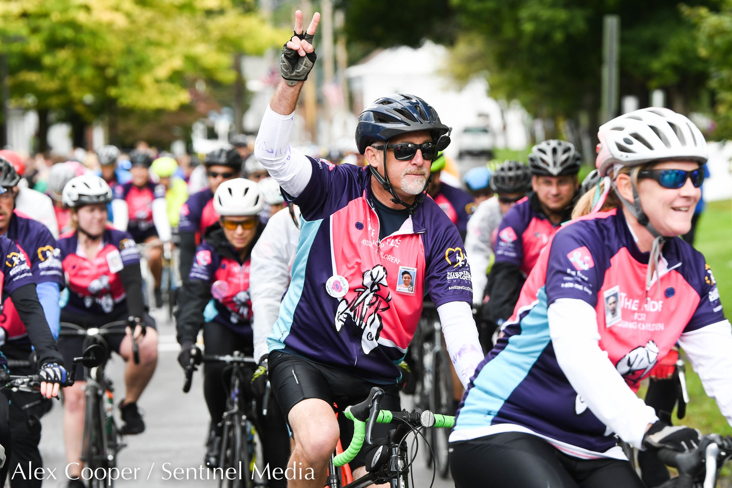 A rider flashes the peace sign after a short break during the 24th annual Ride For Missing Children on Wednesday, Sept. 28 outside of Gregory B. Jarvis Middle School in Mohawk.