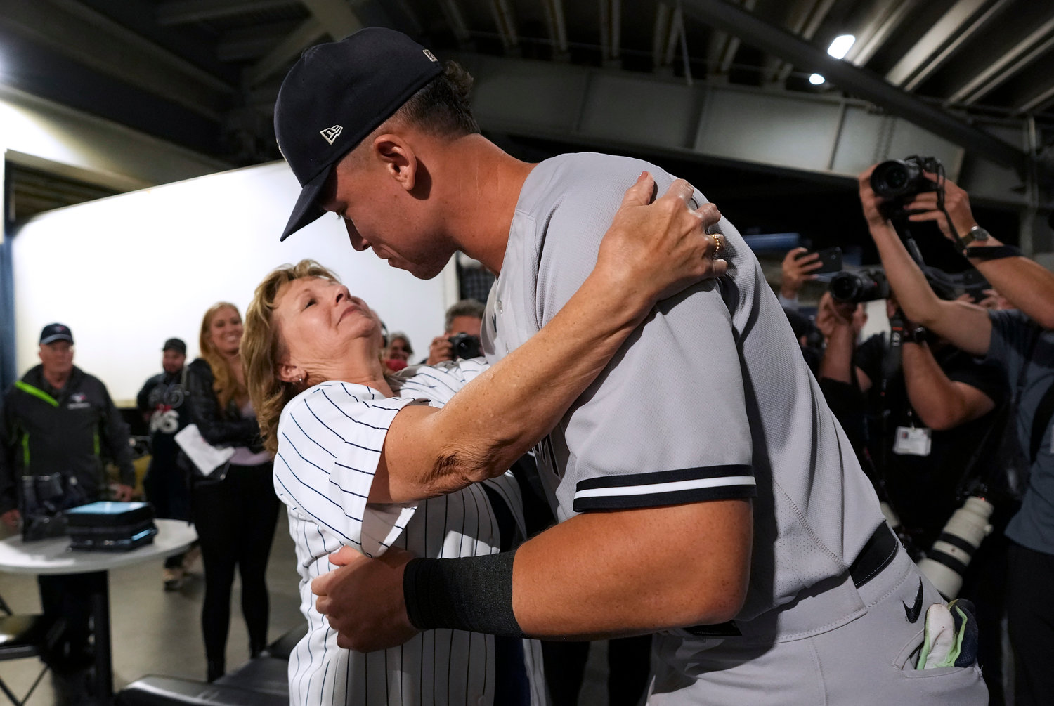 New York Yankees slugger Aaron Judge hugs his mother, Patty Judge, after the team’s game against the Toronto Blue Jays on Wednesday night in Toronto. Judge hit his 61st home run of the season.