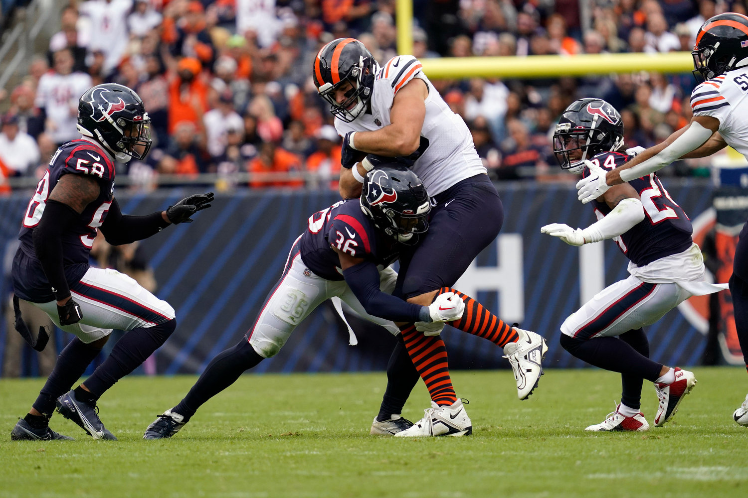 Houston Texans safety Jonathan Owens (36) tackles Chicago Bears tight end Cole Kmet during the second half of an NFL football game Sunday, Sept. 25, 2022, in Chicago.
