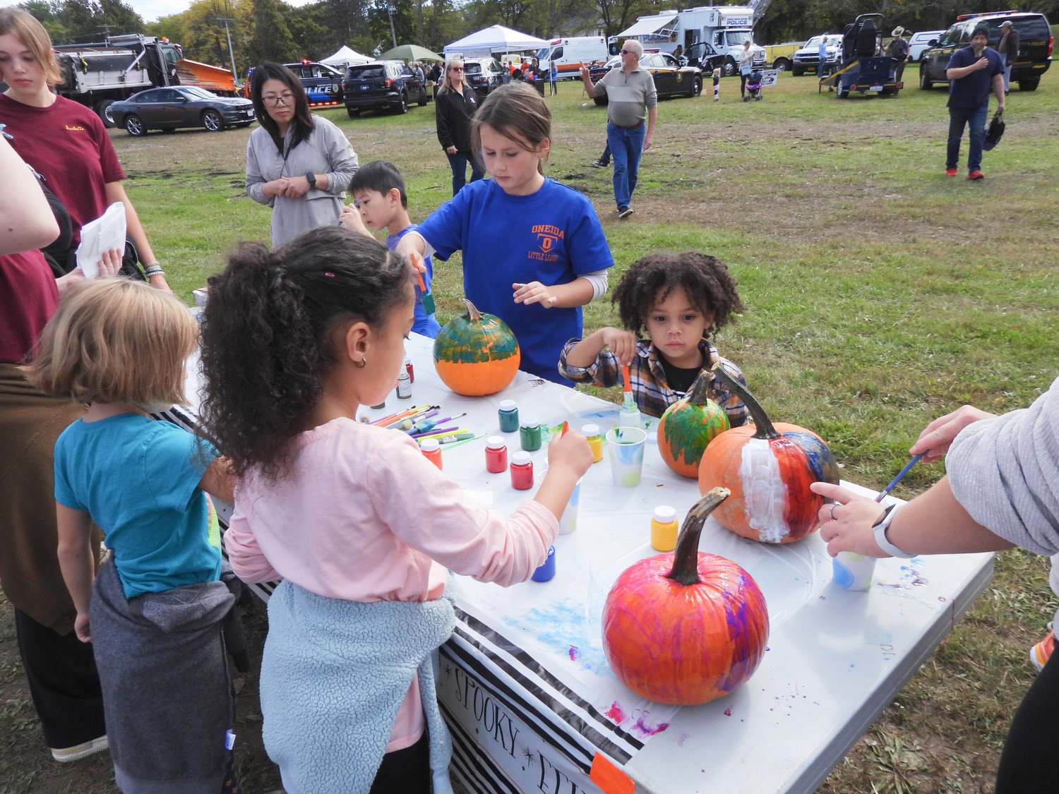 Children attending the second annual Oneida Fall Fest paint pumpkins, free of charge to take home.