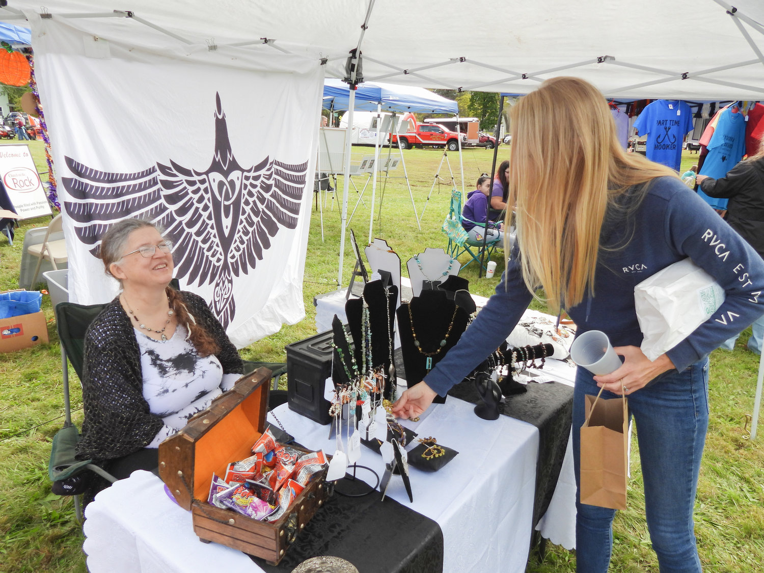 Lisa Fish, left, a resident of Oneida and owner of Magpie Mercantile, sells her handmade jewelry at the second annual Oneida Fall Fest on Saturday, Oct. 1.