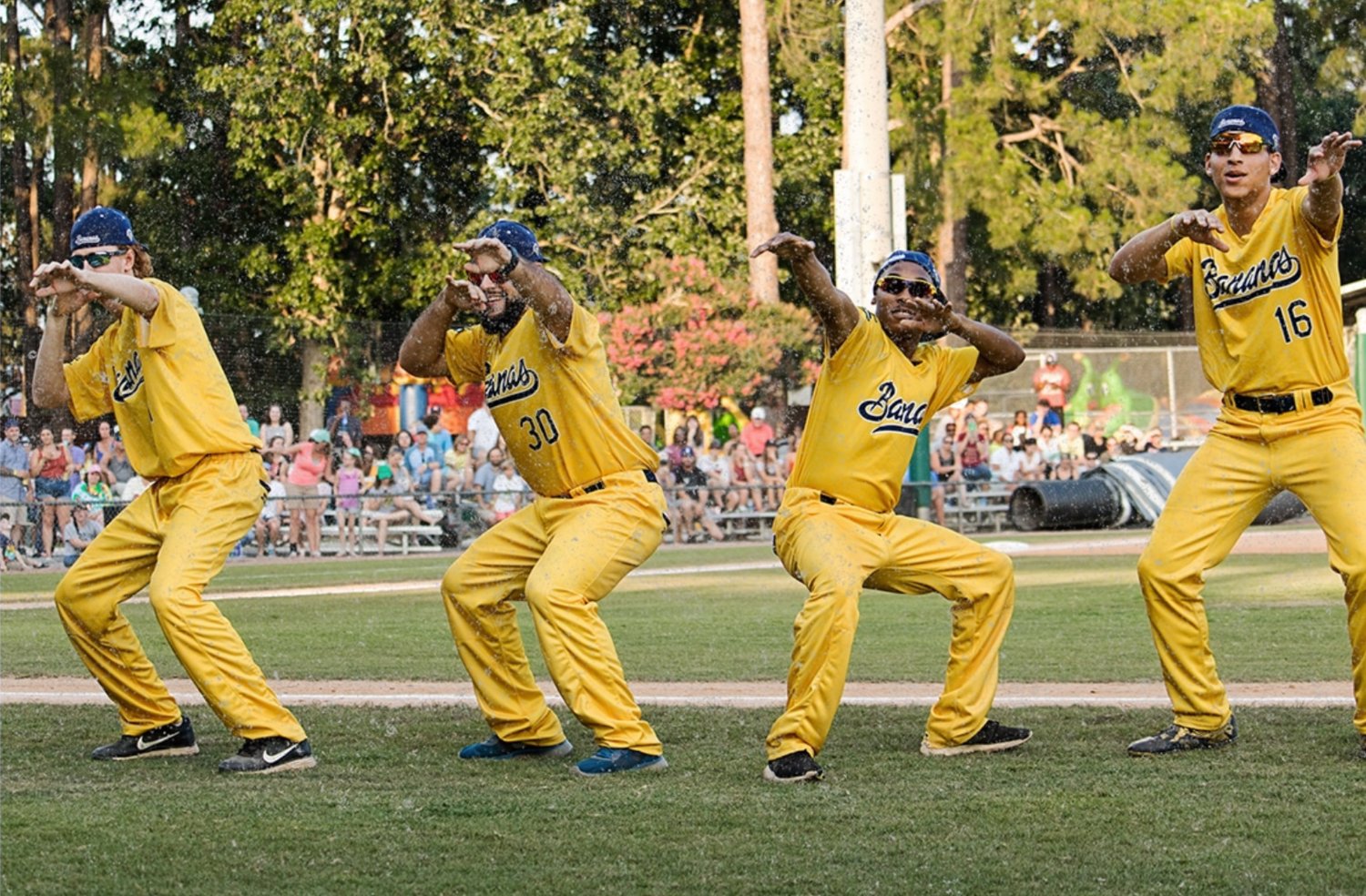 Members of the Savannah Bananas baseball team strike a pose as they dance during a recent game. In addition to accomplished baseball players, the team is also known for a variety of dance moves and attention-grabbing performances.