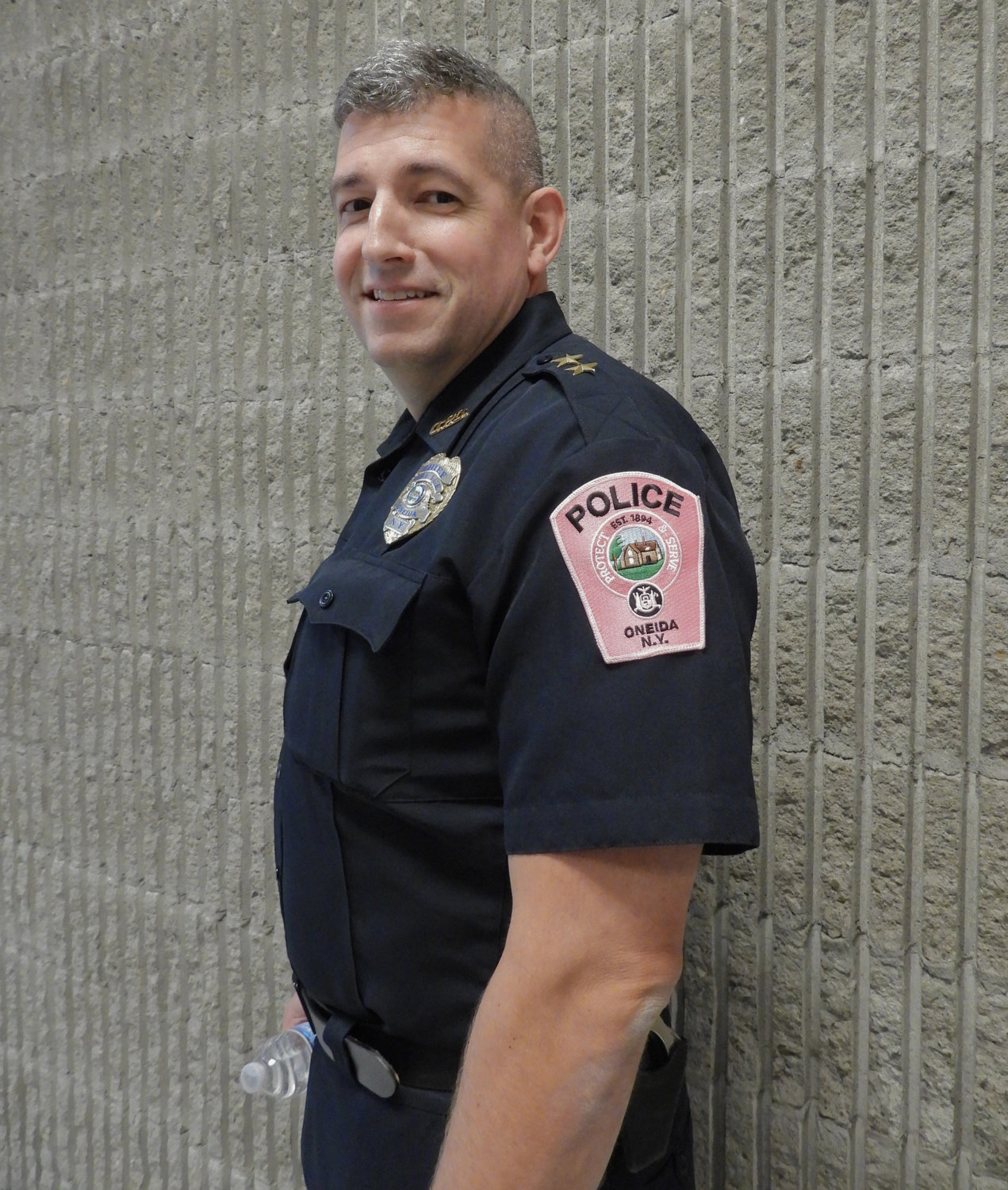 Oneida Police Chief John Little sports a pink badge, in honor of Breast Cancer Awareness Month at Tuesday’s meeting of the Common Council. Little thanked all those who helped to make the second annual Oneida Fall Fest a success.