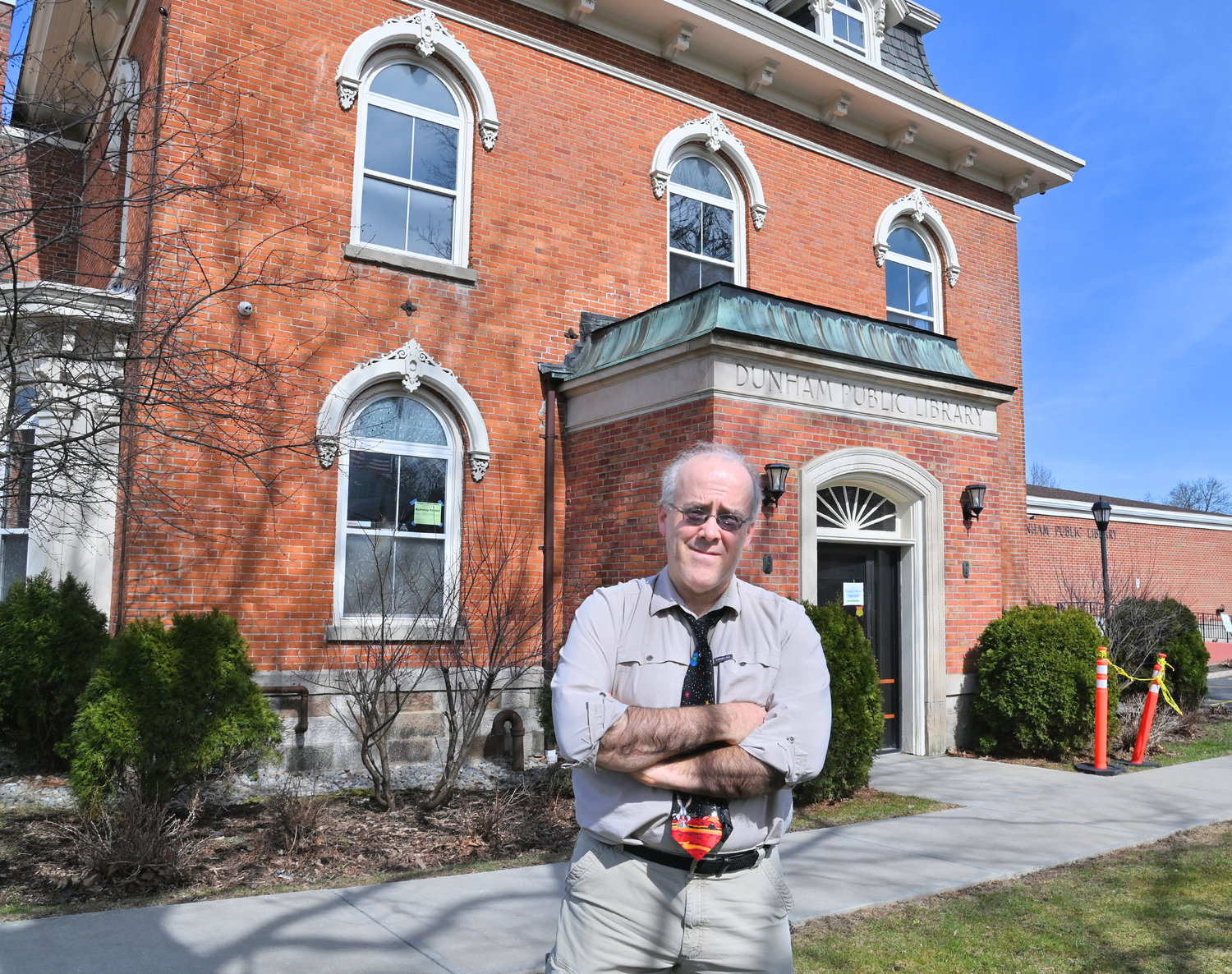 The Dunham Public Library, 76 Main St., shown with Adult Services Librarian Dennis Kininger in this file photo from earlier this year, dates back to the pre-Civil War era and became a library in October 1926. The facility’s capital project has received $323,625 in state funding for the rehabilitation of Dunham House, including a bay window, toilet room, kitchenette, office dividing wall, technology and electrical work.