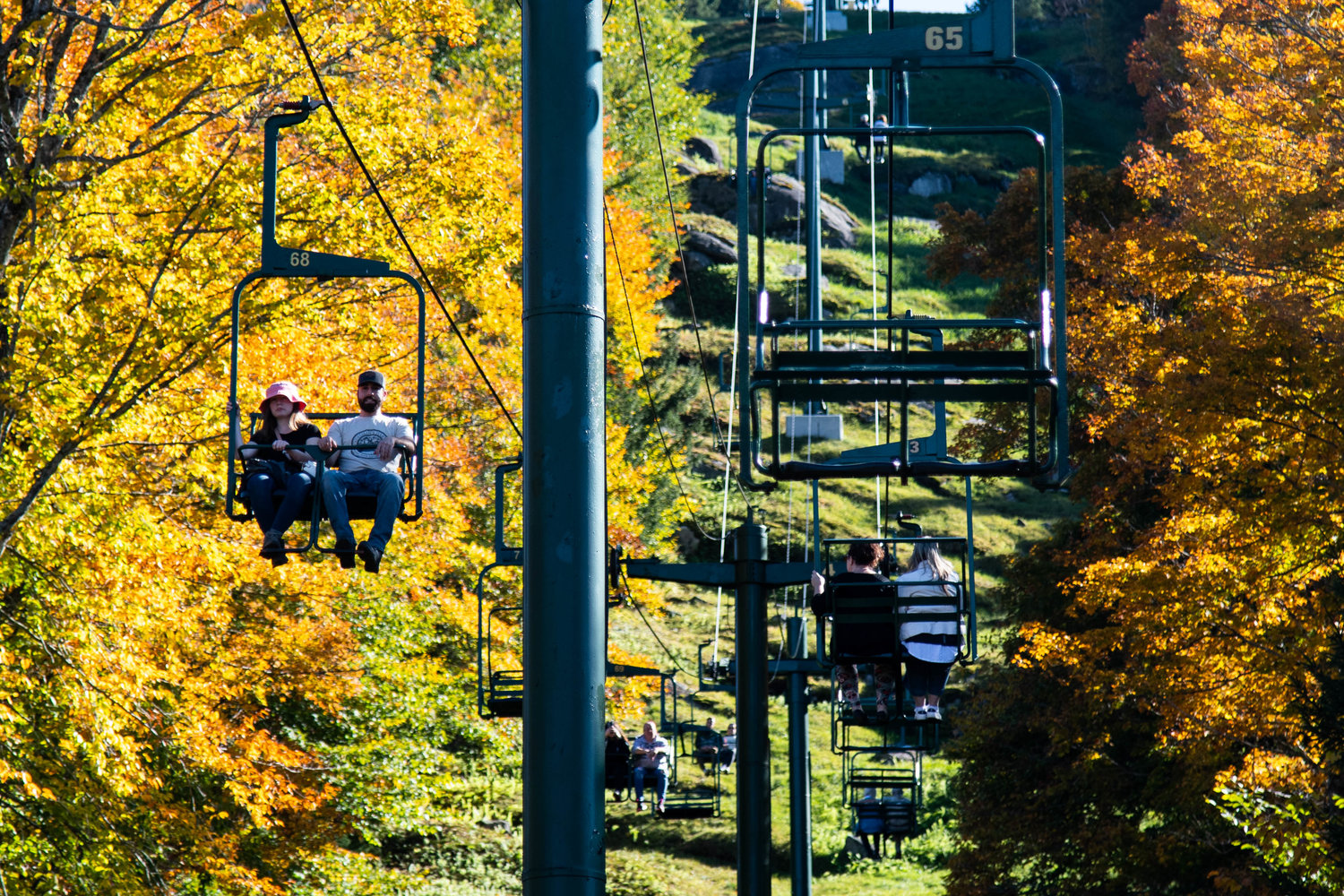 People ride the scenic chairlift ride at McCauley Mountain on Wednesday, Oct. 5, in Old Forge. Guests are able to view peak fall foliage from the lift and top of the mountain.