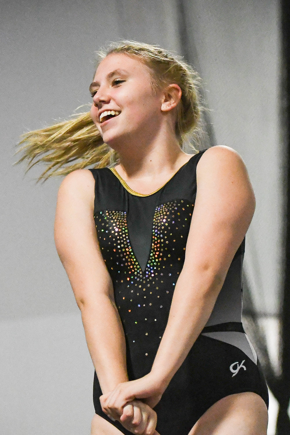 Rome Free Academy's Kyley Kuehnert smiles at her coach before competing in gymnastics on Thursday at Valley Gymnastics in Utica.