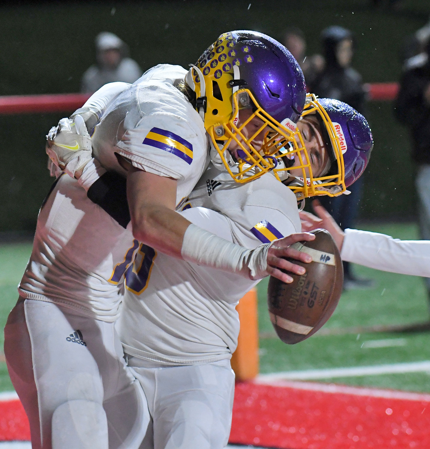 Holland Patent senior tight end Nick Deforrest, left, gets a big hug from teammate Jordan Carhart after catching a touchdown pass late in the second quarter at Vernon-Verona-Sherrill Friday night. Deforrest caught two scores from Aidan Rubas to get the Golden Knights a 14-6 win in Class C.
