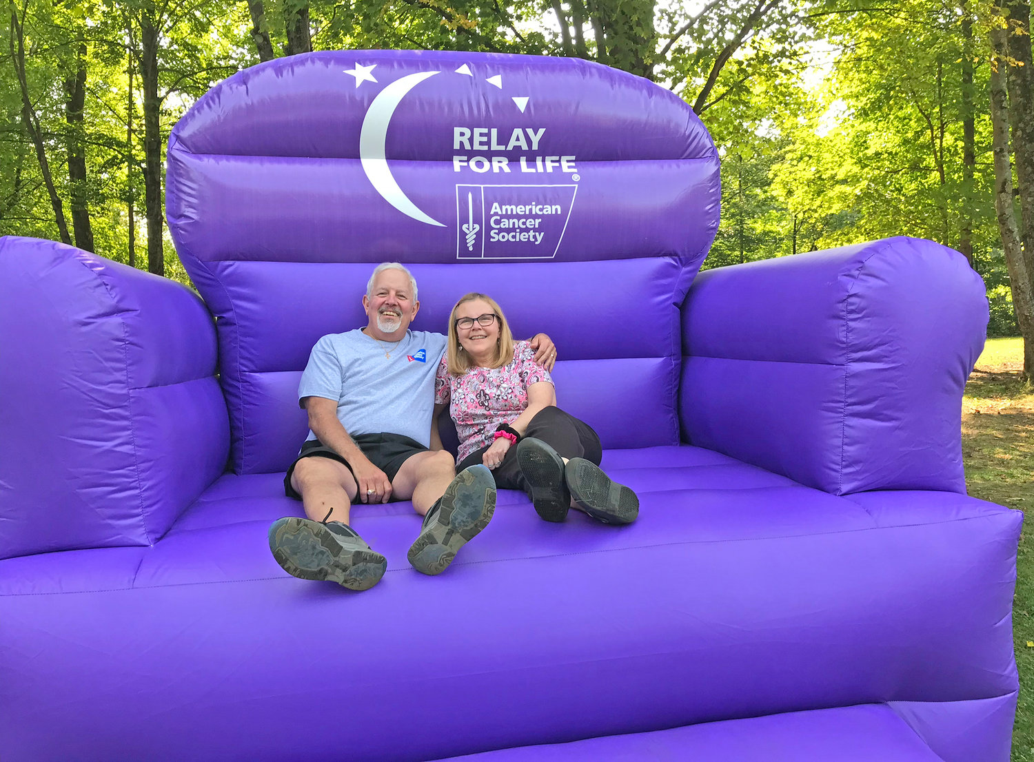 Bernie Szczesniak, left, and his wife, Jackie, sit for a photo Sept. 17 in the "big purple chair" at the Relay for Life of Central New York in Delta Lake State Park in Rome. Bernie is a breast cancer survivor.
