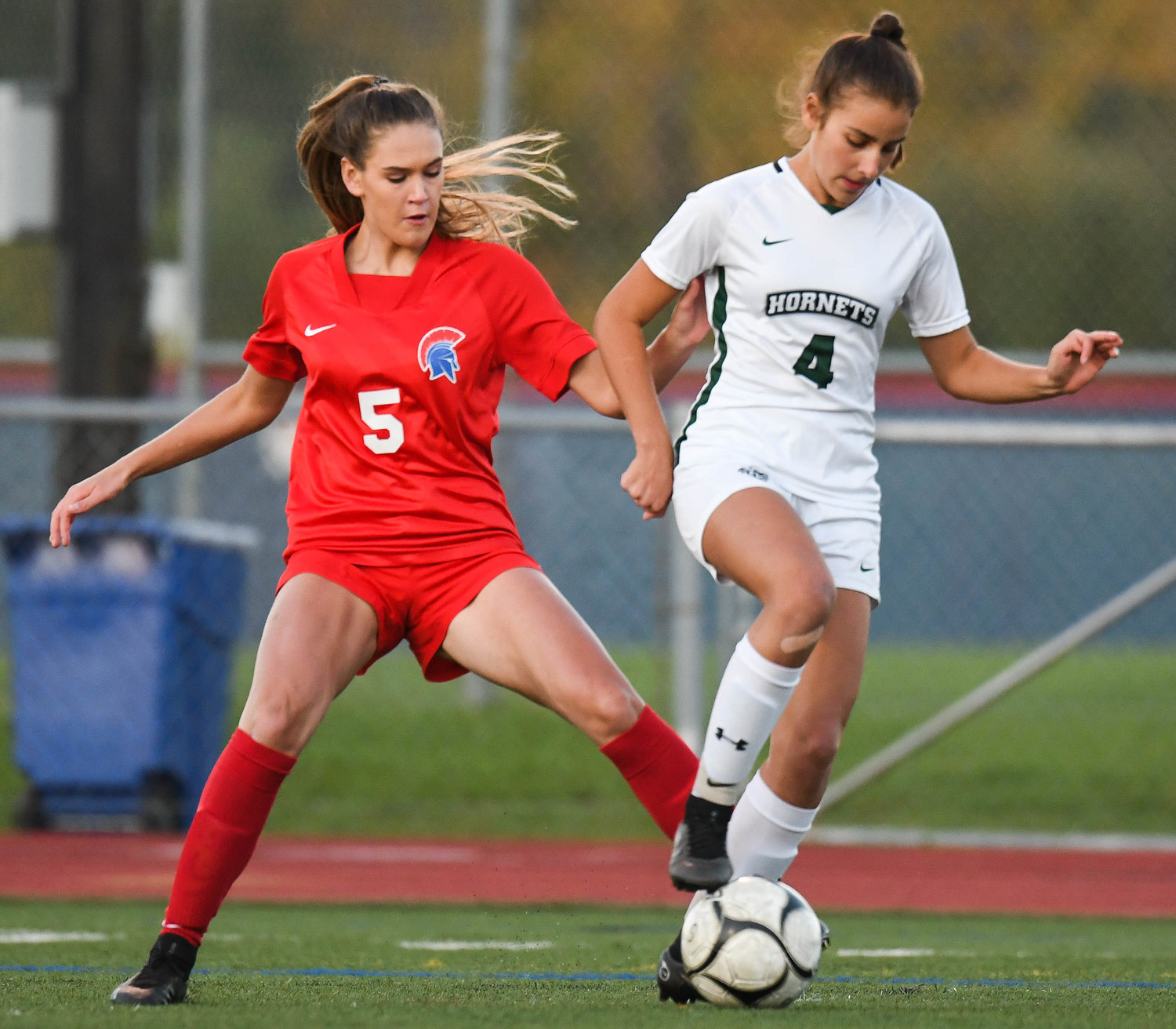 New Hartford's Alex Volo, left, fights for control of the ball against Fayetteville-Manlius' Una Vlasak during a game on Monday night in New Hartford. The Spartans won 4-0 on Senior Night, which honored nine players including Volo.