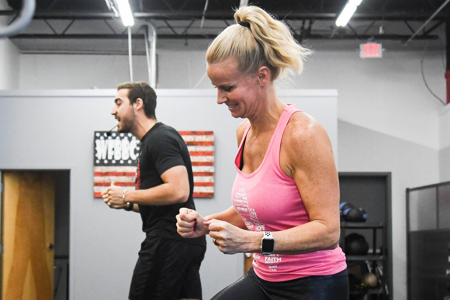 Lisa Briggs and Dominic Caccioppoli lead a fitness group on Monday, Oct. 10 at Whitesboro Fit Body Boot Camp. The gym is raising money for breast cancer and honoring all of the women in the gym that have battled breast cancer.