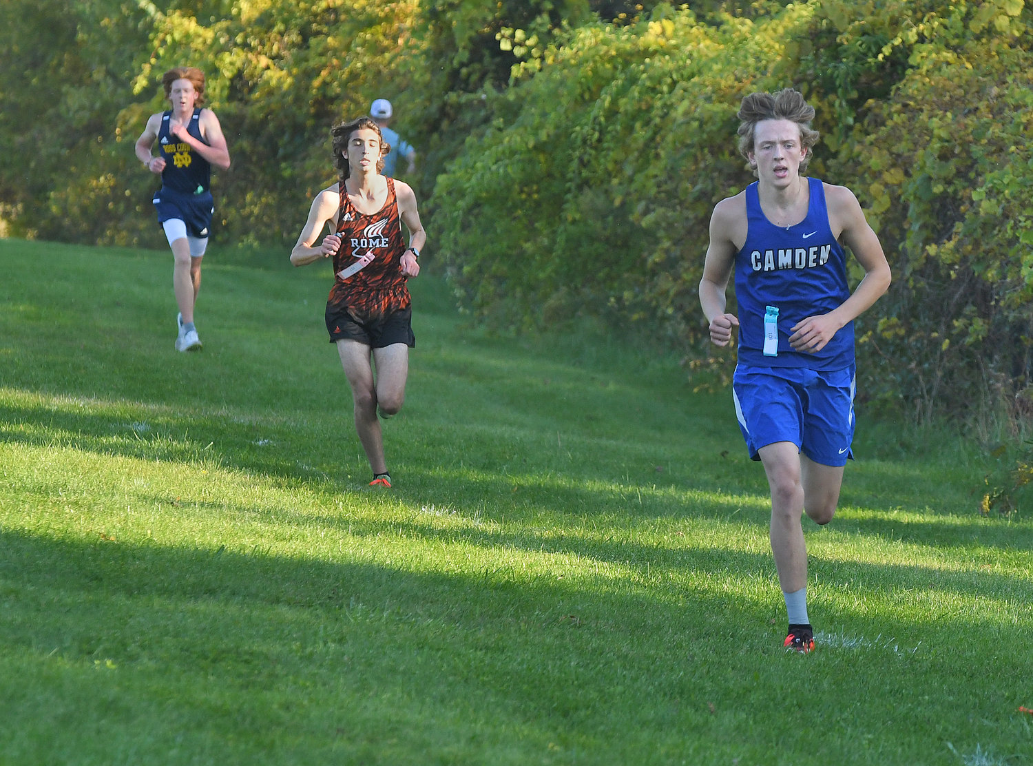 Camden’s Jerome Seidl leads Rome Free Academy’s Carson Campbell at the start of the second lap of Tuesday’s cross country race at RFA. Seidl went on to get the win the race in 18:58.21, with Campbell in second place. RFA defeated both Camden and Utica-Notre Dame in team points.