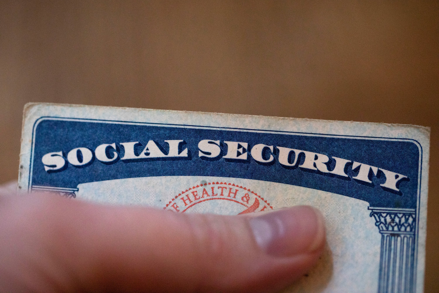 FILE - A Social Security card is displayed on Oct. 12, 2021, in Tigard, Ore. Millions of Social Security recipients will soon learn just how high a boost they'll get in their benefits next year. The increase to be announced on Thursday, Oct. 13, 2022, expected to be the highest in 40 years, is fueled by record high inflation and is meant to help cover the higher cost of food, fuel and other goods and services.