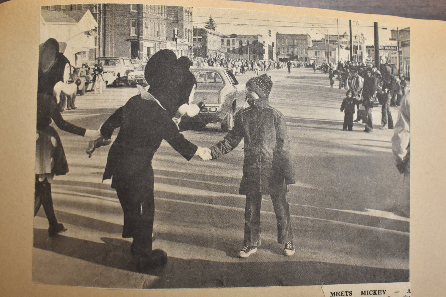 This newspaper photo is from downtown Oneida in the early 70s. Its caption reads: "Meets Mickey - A youngster steps out from the curb along the crowded Main St. to shake hands with Mickey Mouse who is holding Minnie Mouse's hand during the spring parade here. Other Disney characters in the parade were Cinderella and Freddy the Chimney Sweep. The Disney characters are in the area for Disney on Parade being held in Utica for a week beginning Tuesday."
