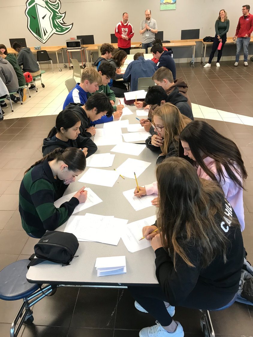 Members of the New Hartford Central School Mathletics team work on their group brain teaser problem Saturday during their first meet of the season, and first in-person meet since the start of the pandemic, at Hamilton Central School