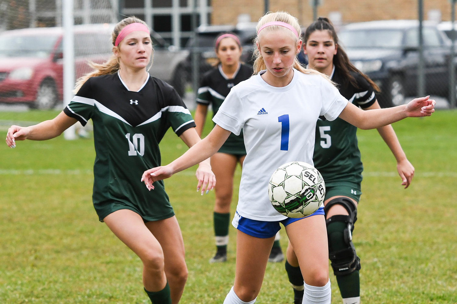 Dolgeville's Emily Metz settles the ball as Westmoreland players Victoria Downs (10) and Madalynne Enos (5) close in during the game on Tuesday. Dolgeville, the 11 seed, got a 1-0 upset win over the six seed Bulldogs.