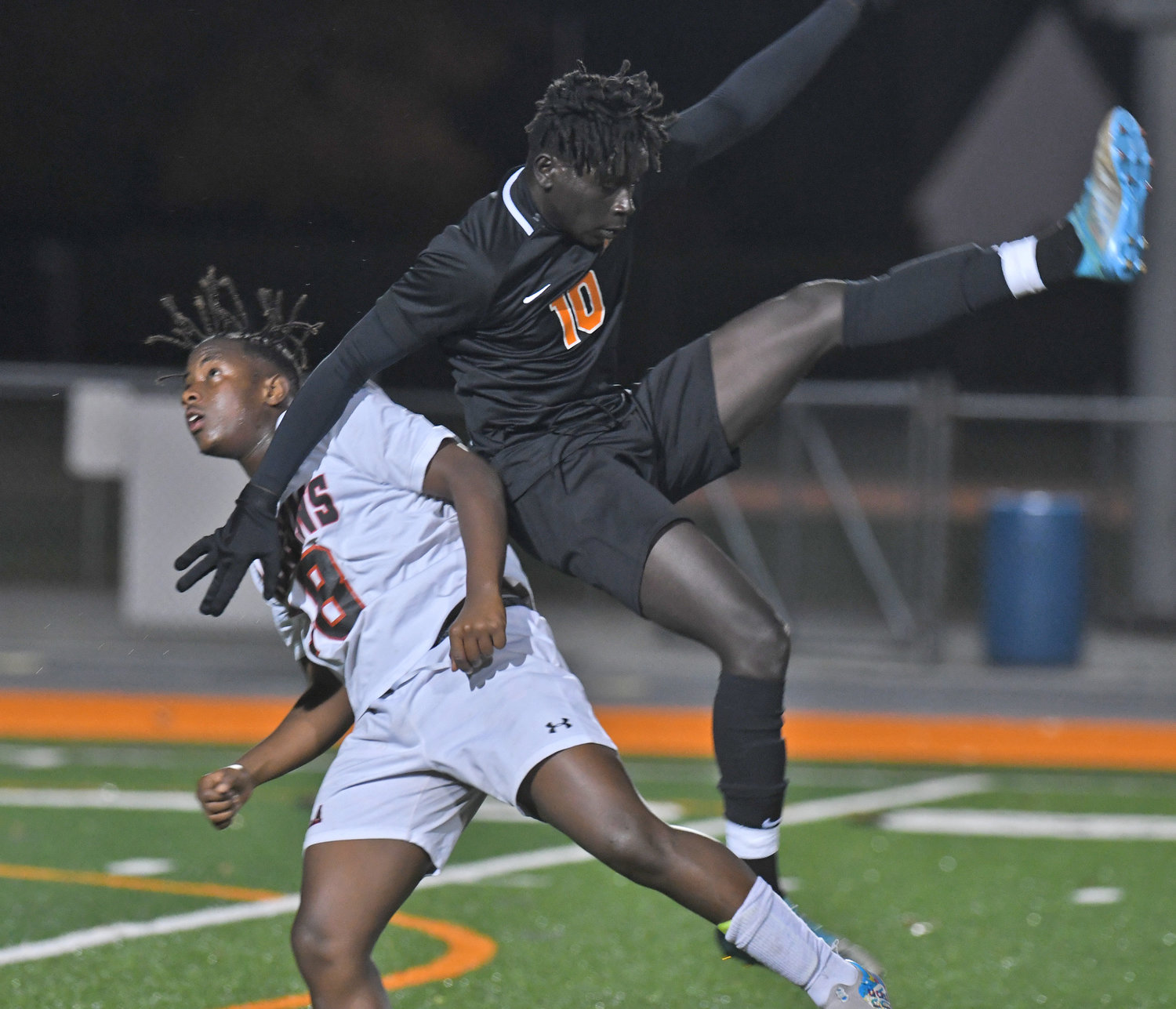 Rome Free Academy's Amanuel Mellace goes airborne in a battle for the ball against Fowler's Jackson Indihafiki in the first half Wednesday night at RFA Stadium. RFA got a late goal to earn a 1-0 win in the Section III Class AA opening round playoff win.