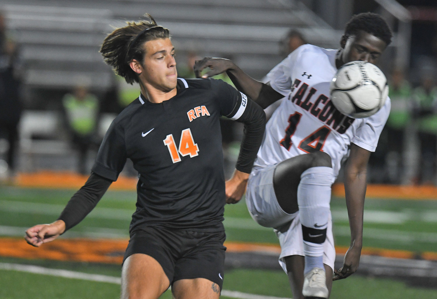 Collin Gannon of Rome Free Academy, left, turns as Fowler's Simon Irankunda controls the ball in the first half Wednesday night at RFA Stadium. RFA won 1-0 on a late goal to advance to the quarterfinals of the Section III Class AA playoffs.