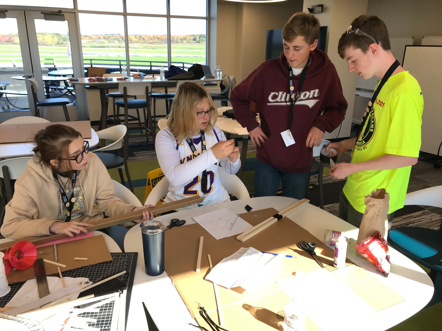 Engineering Wars participants, from left, Savanah Smutz, Addyson Carrier, Wyatt Forbes and Caden Salzburg from Oneida-Herkimer-Madison BOCES build their competition entry Friday at the Innovare Advancement Center in Rome.