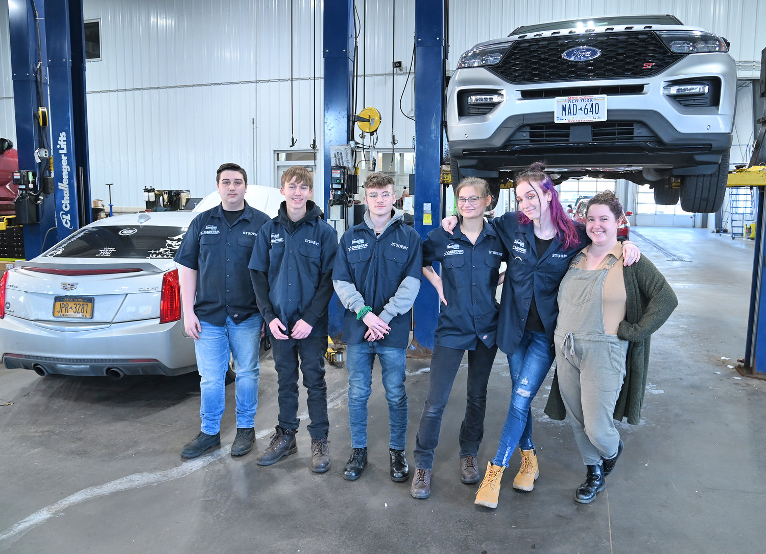 Madison-Oneida BOCES students, from left, Kristian Streiff and Joe Corigliano from Rome Free Academy, Dillon Walters from Oneida, Faith Bunal and Tailor Pope from RFA and Teacher Assistant Ashley Esengard pose Friday, Oct. 21, at the CARSTAR Davidson Collision facility in Rome.