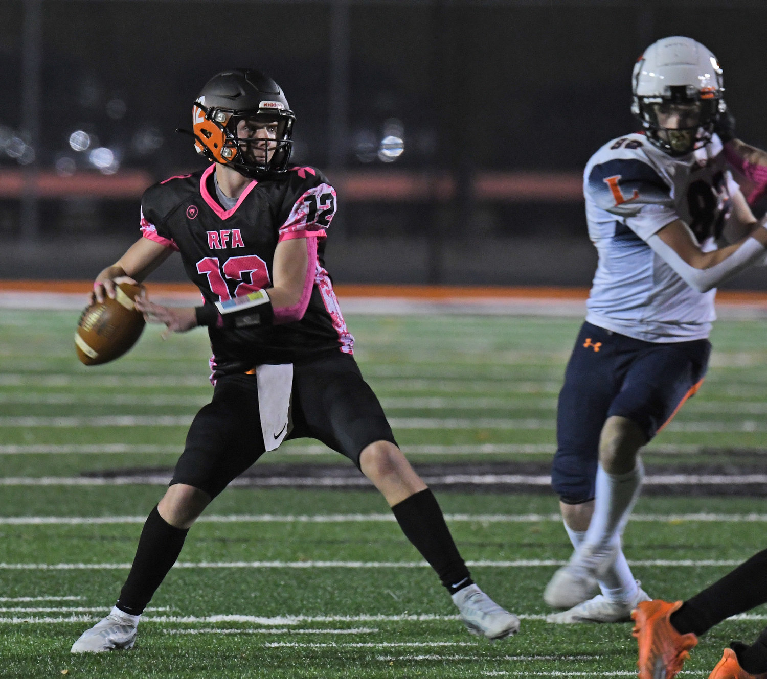RFA junior Evan Carlson-Stephenson winds up for a touchdown pass in the first half against Liverpool on Friday night at RFA Stadium. He had 186 yards passing.