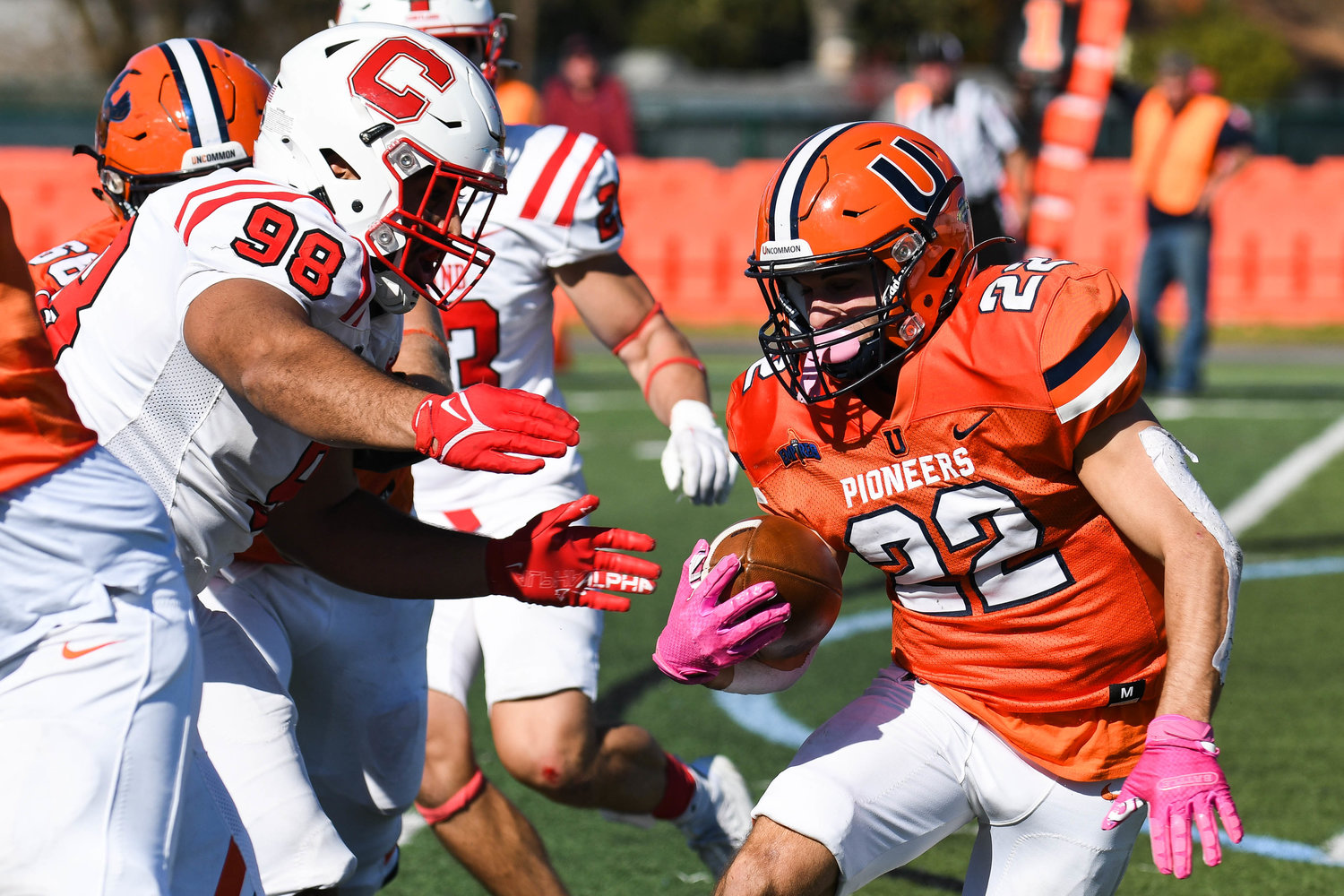 Utica University wide receiver Nate Palmer (22) avoids a tackle from SUNY Cortland defender Matt Ferrer (98) during the Empire 8 game on Saturday afternoon at Charles A. Gaetano Stadium in Utica. The Pioneers lost 48-21.