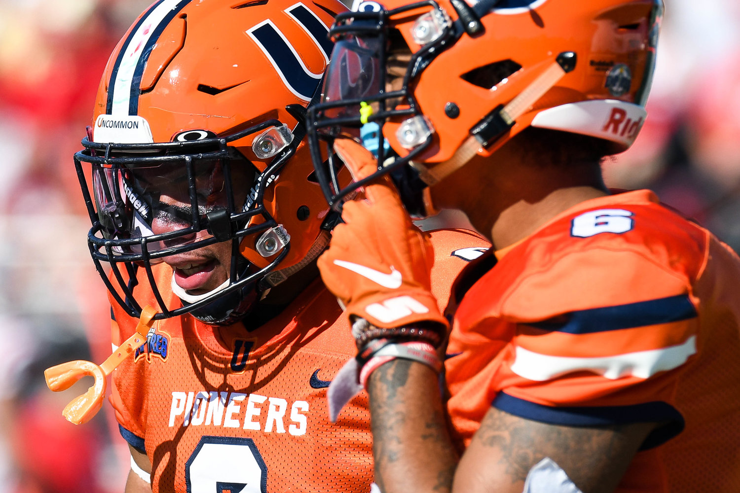Utica Pioneers players Darius Johnson and Cameron Davis talk after a play during the Empire 8 game against SUNY Cortland on Saturday afternoon at Charles A. Gaetano Stadium in Utica.