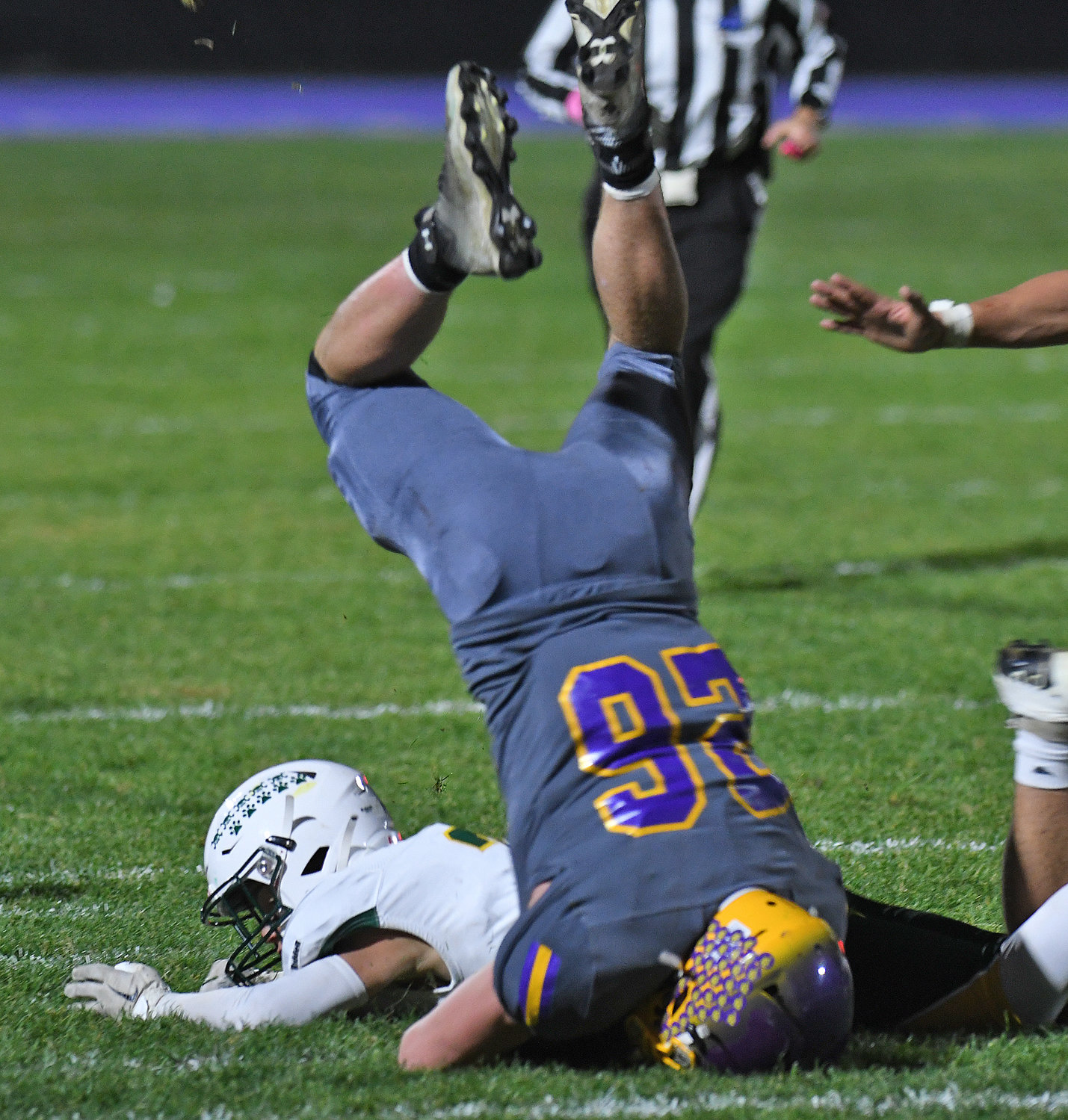Holland Patent running back Jordan Koenig gets upended by Adirondack defensive back Braden White Saturday night at Holland Patent. Adirondack won 46-0, holding the Golden Knights’ offense in check all game.