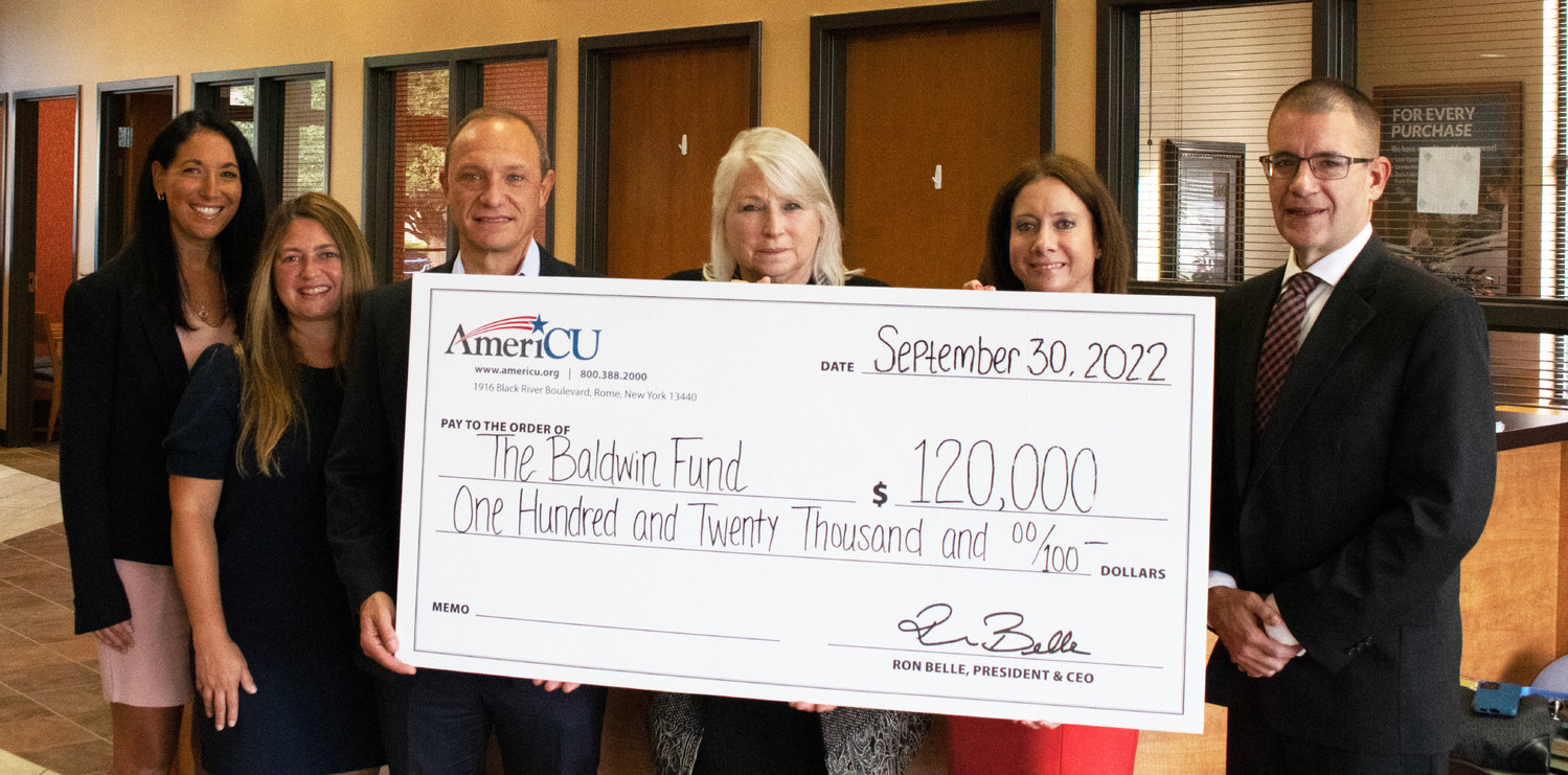From left: Andrea MacDiarmid, Kristy Nole, Ron Belle, Beth Baldwin, Rachel Siderine and Mike Smith during AmeriCu’s check presentation to The Baldwin Fund.