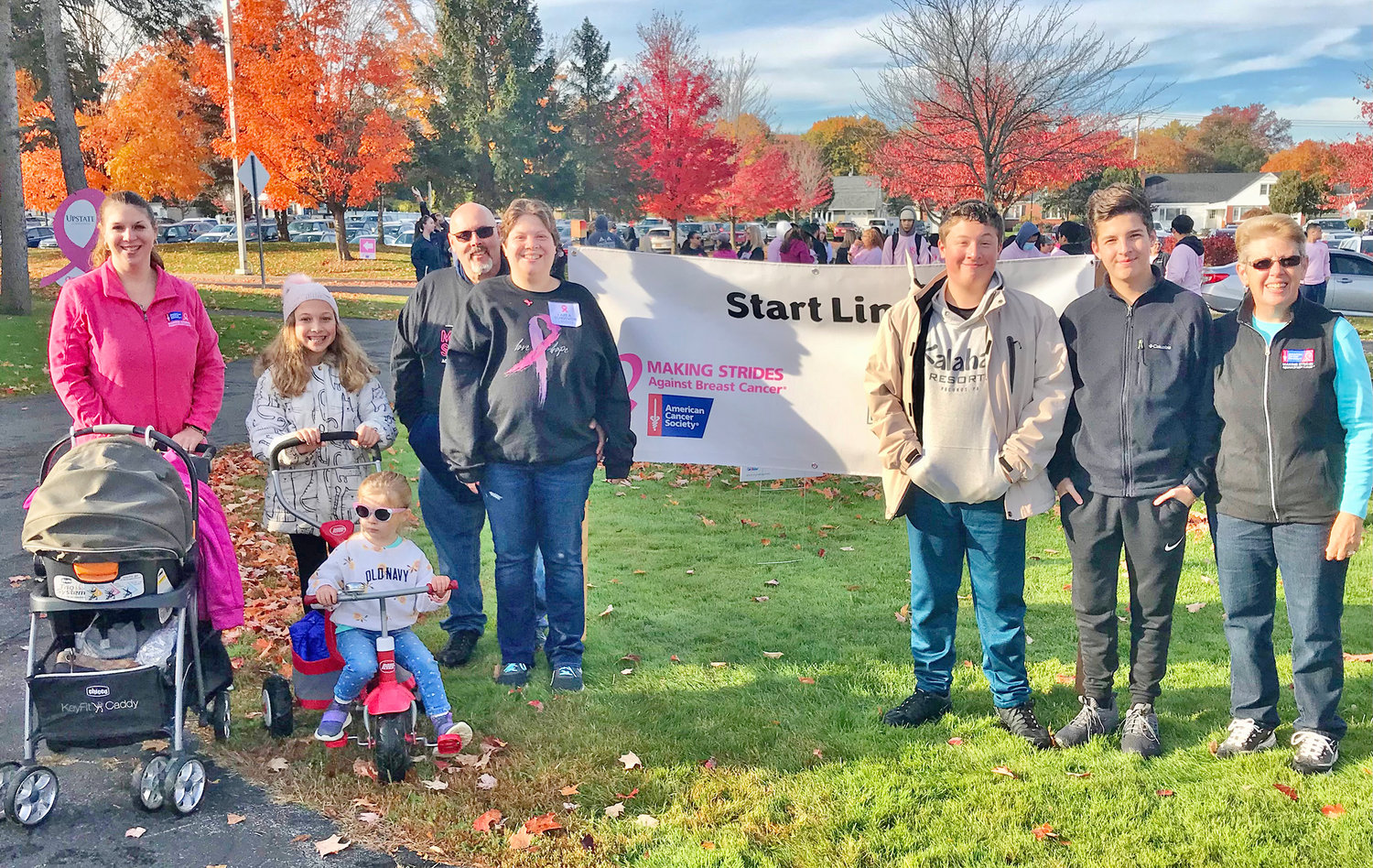 Supporting Katie Waltermire, center left, Sunday at the starting line of the American Cancer Society’s Making Strides Against Breast Cancer walk in Utica are, from left, her sister Joanna Marshall with son Jaxson in the stroller, her daughter McKenzie and niece Brianna on the bike, her boyfriend John Monette, sons Ethan and Tim and mom, Janet Stevens.
