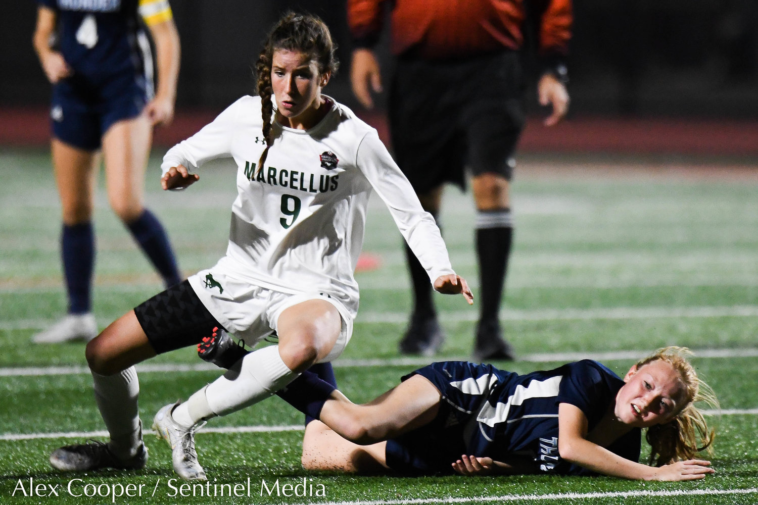 Central Valley Academy player Jenna Johnson falls to the the turf after colliding with Marcellus player Claire Card (9) during the Class B girls soccer semifinals game on Wednesday, Oct. 26 at Chittenango High School. CVA won 2-0.