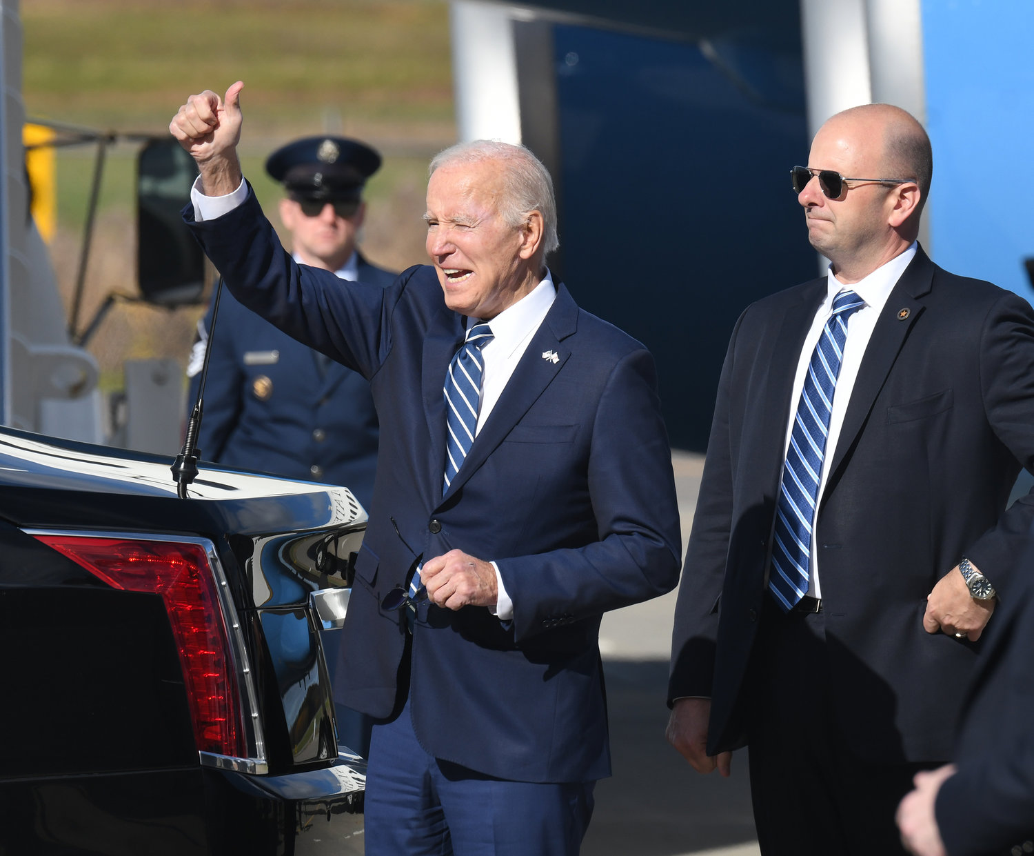 GREETINGS — President Joseph Biden waves to family and friends gathered at Syracuse's Hancock International Airport to welcome the 46th president of the United States upon his arrival to Syracuse on Thursday, Oct. 27. Following his arrival on Air Force One, Biden was wisked away in a large motorcade from the airport down Route 81 as he headed to Onondaga Community College to discuss the new Micron factory and its impacts on upstate New York and the nation. With Biden is a member of his security detail.