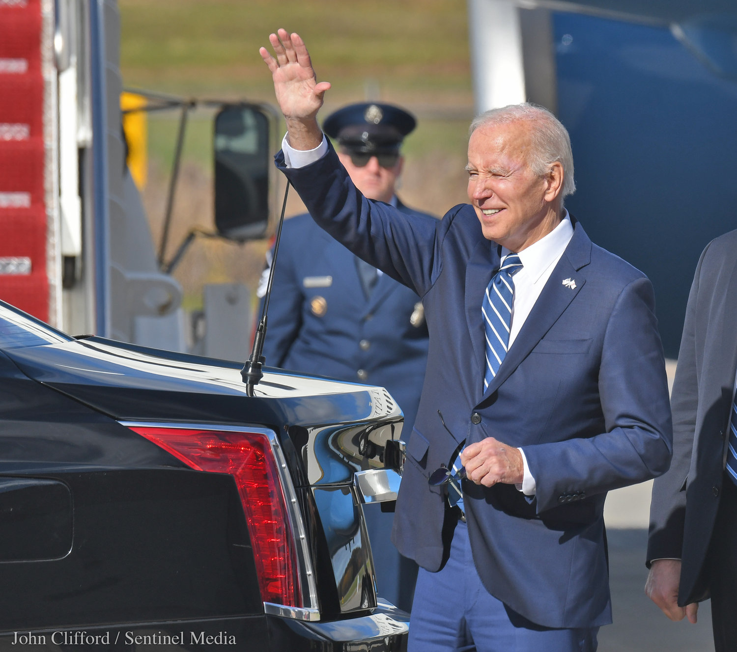President Joe Biden waves to people that attended his arrival in at Hancock International Airport for his visit to Syracuse Thursday, Oct. 27, 2022.