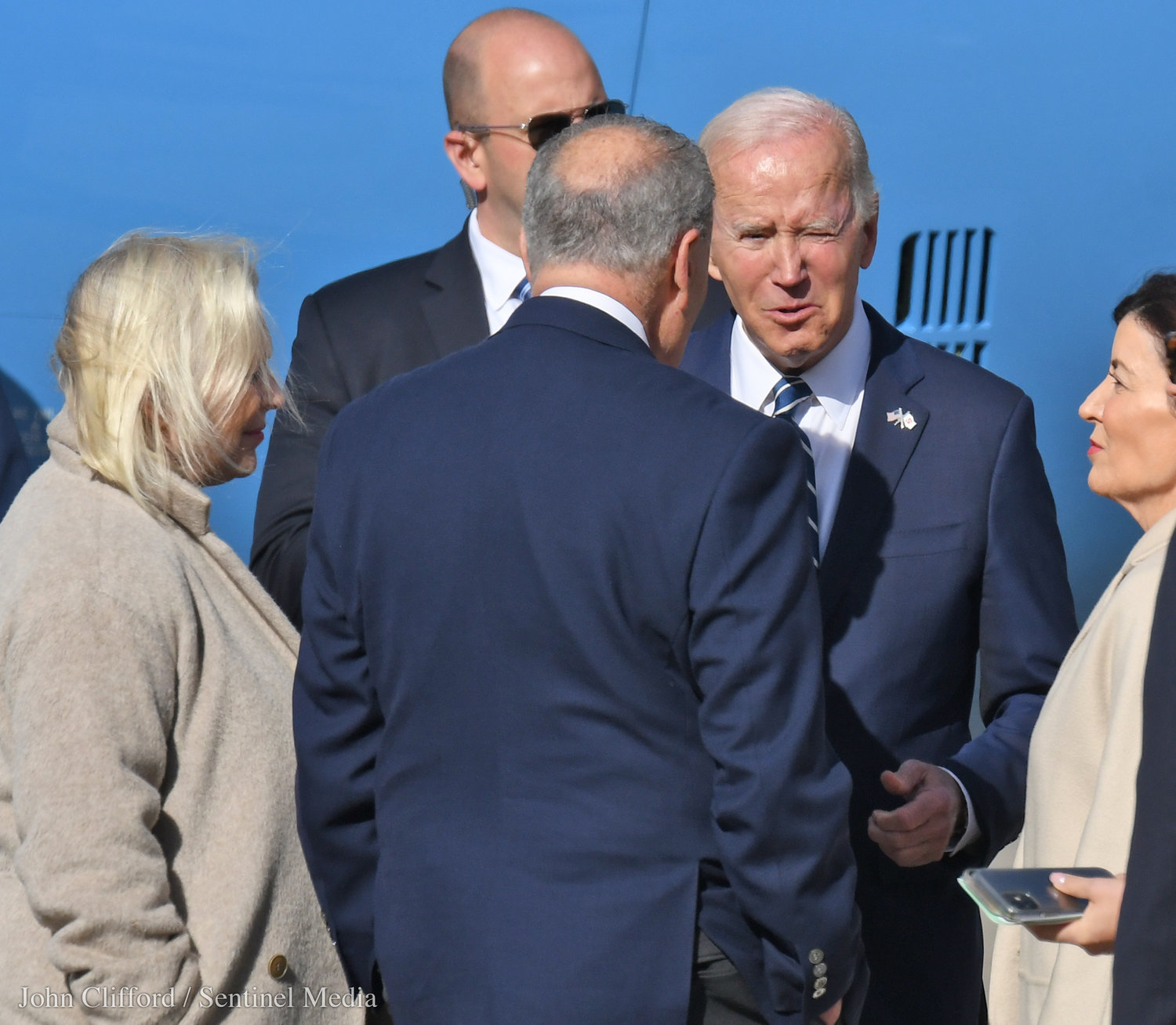 President Joe Biden chats with Gov. Kathy Hochul, Senator Chuck Schumer and Senator Kirsten Gillibrand after landing at Hancock International Airport for his visit visit to Syracuse Thursday, Oct. 27, 2022.