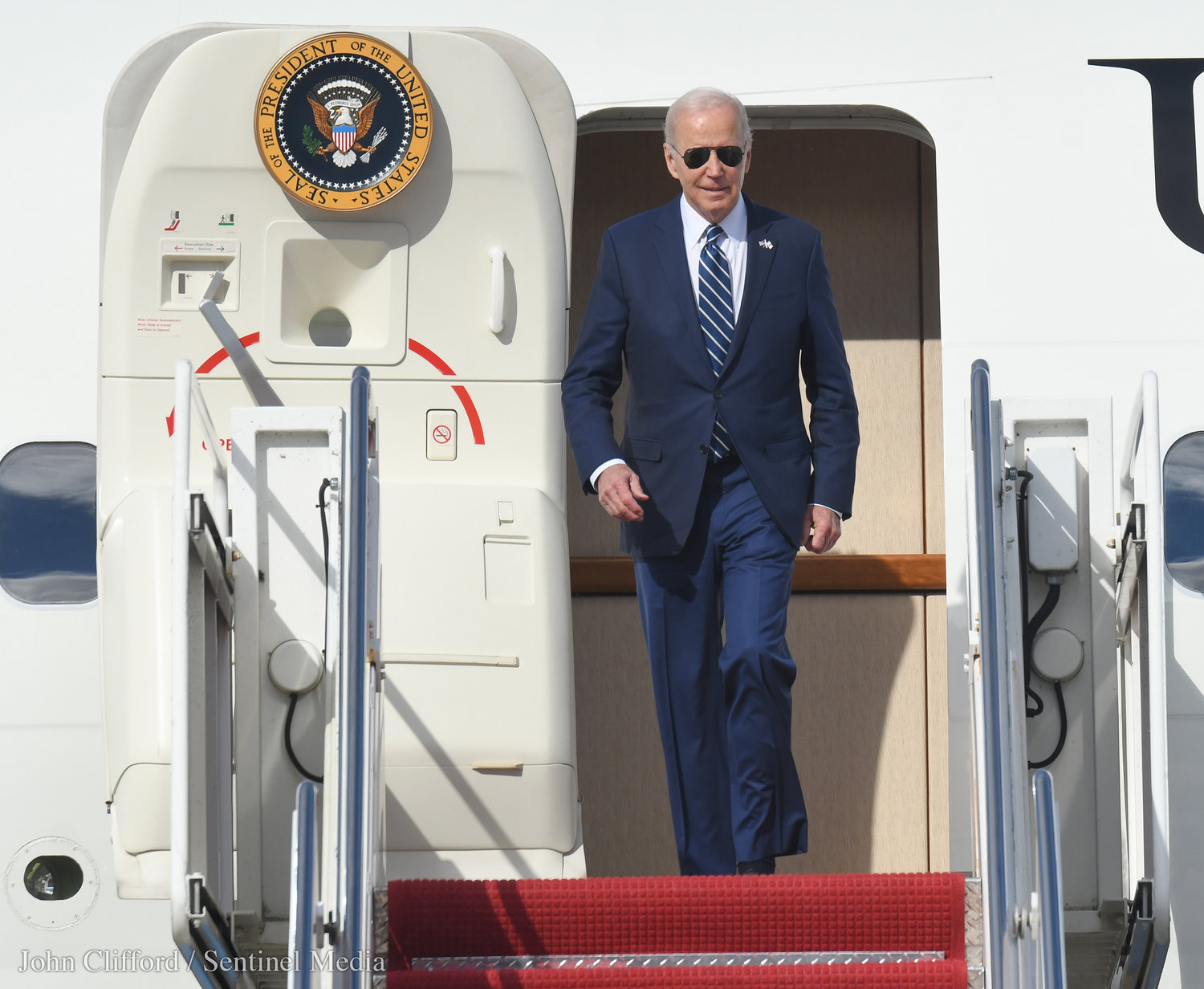 President Joe Biden strides off Air Force 1 after landing at Hancock International Airport for his visit to Syracuse, Thursday, Oct. 27, 2022.