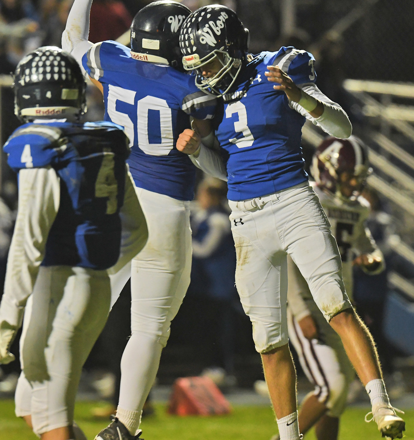 Whitesboro running back Nicholas Polnak, right, and lineman Vincent Zajac celebrate after Polnak scored the Warriors' fourth touchdown of Friday's 42-7 home playoff win over Auburn. Teammate Tony Dorozynski, who had the team's third TD earlier in the first quarter, looks on.